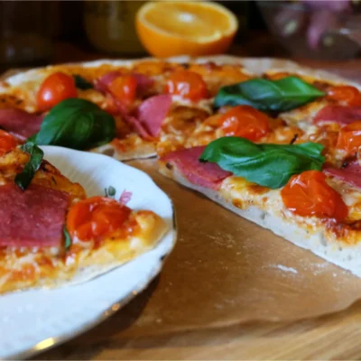 Pizza Aragon slices on table